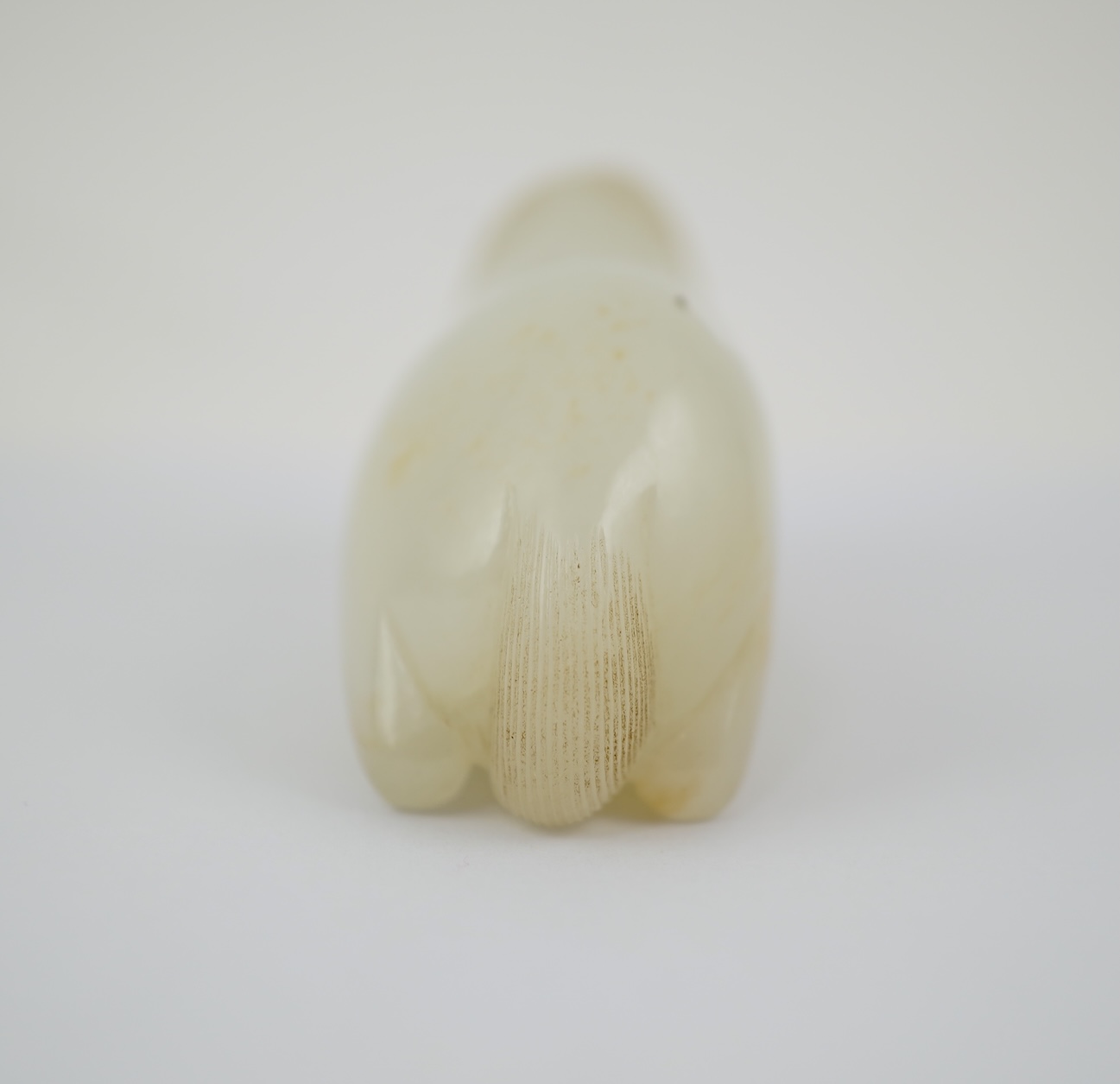 A Chinese white jade figure of a recumbent horse